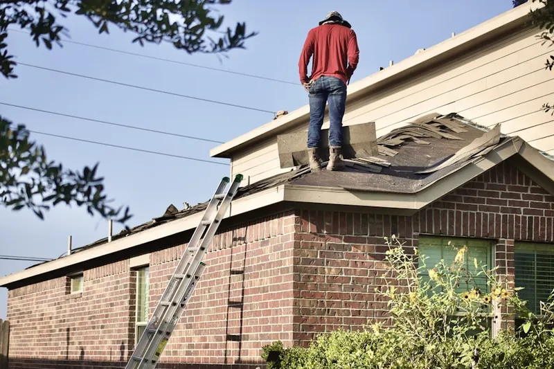 Professional roofer working on a residential roof in Woodland Creek Manor